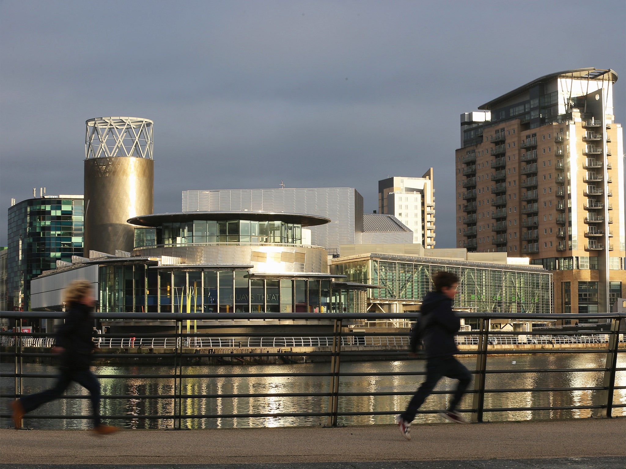 People run by The Lowry Centre and Media City in Salford Quays, Greater Mancheter, which is now home to the BBC (Getty)