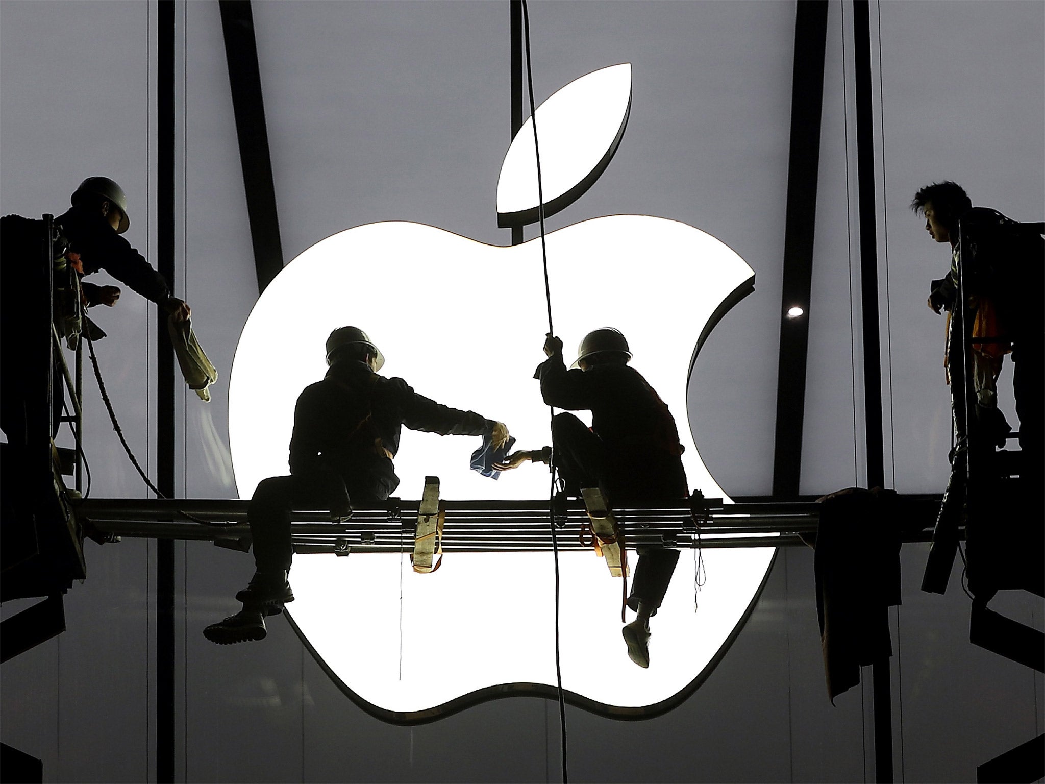 Workers prepare for the opening of a new Apple store in Hangzhou, China