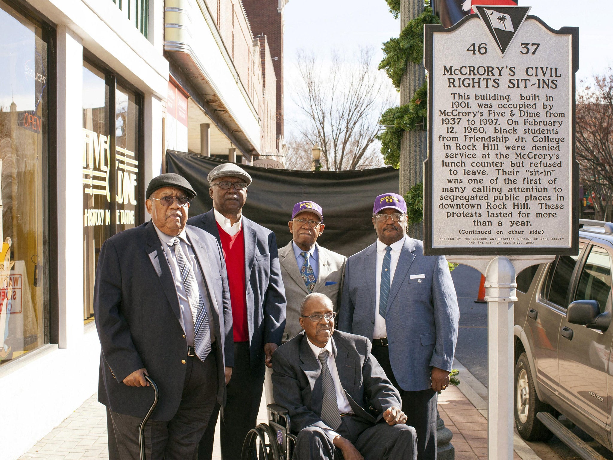 Friendship Nine members (from left to right): Clarence Graham, David Williamson Jr., Willie Thomas Massey, James F. Wells and Willie E. McCleod stand in front of a historical commemorative marker outside the Five & Dine diner in Rock Hill, South Carolina