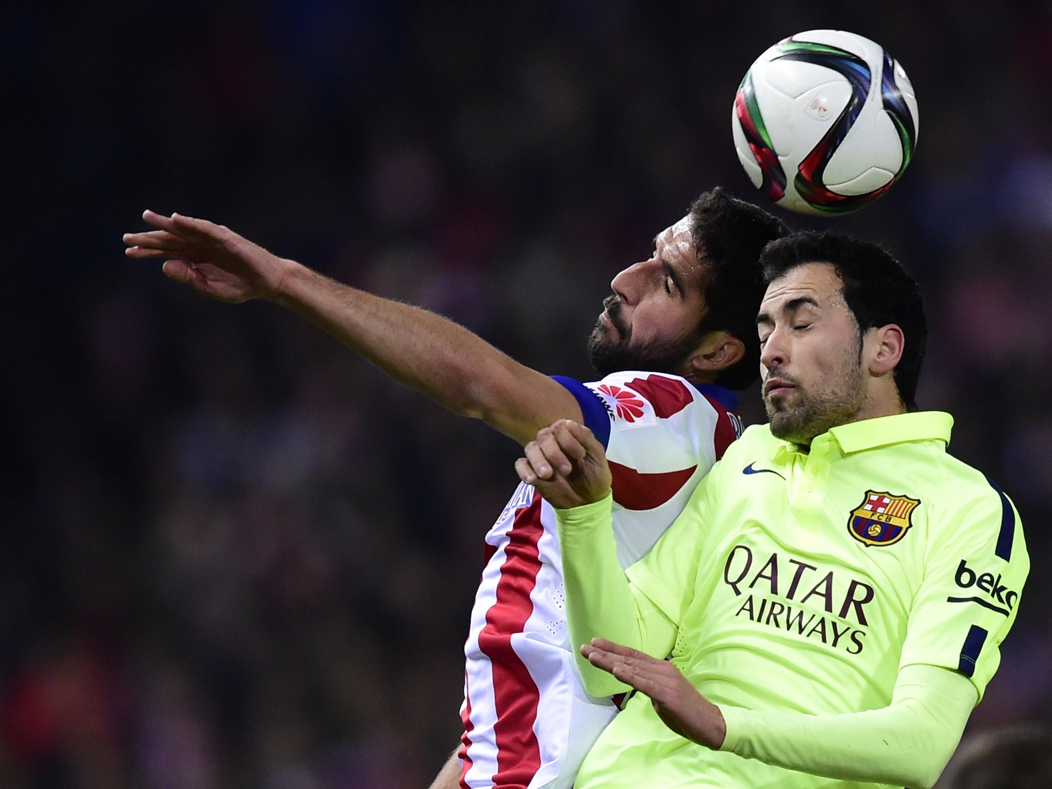 Sergio Busquets challenges for the ball