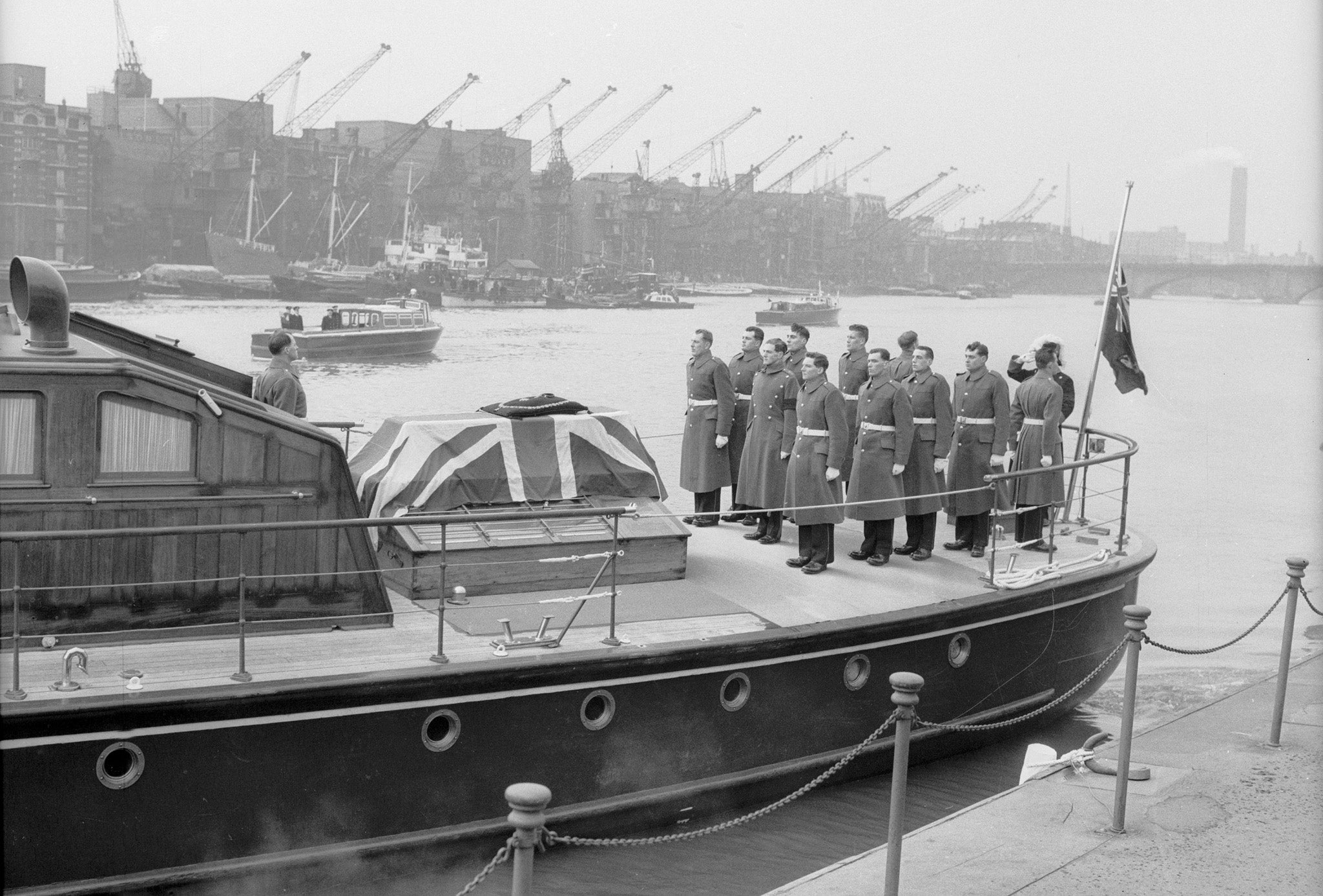 The cranes are lowered by dock workers after Winston Churchill's funeral, 30 January 1965