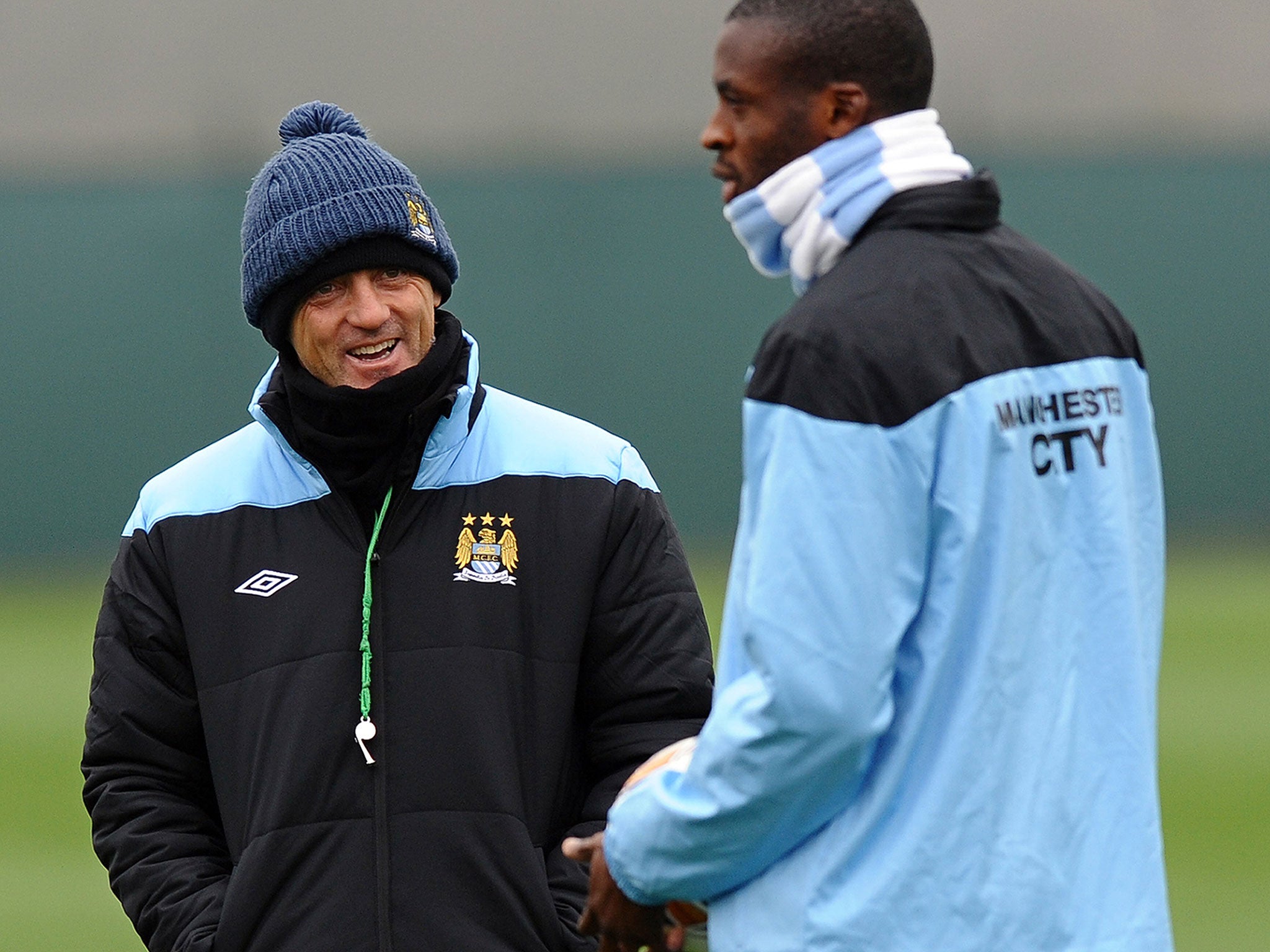 Roberto Mancini (left) and Yaya Toure during Manchester City training