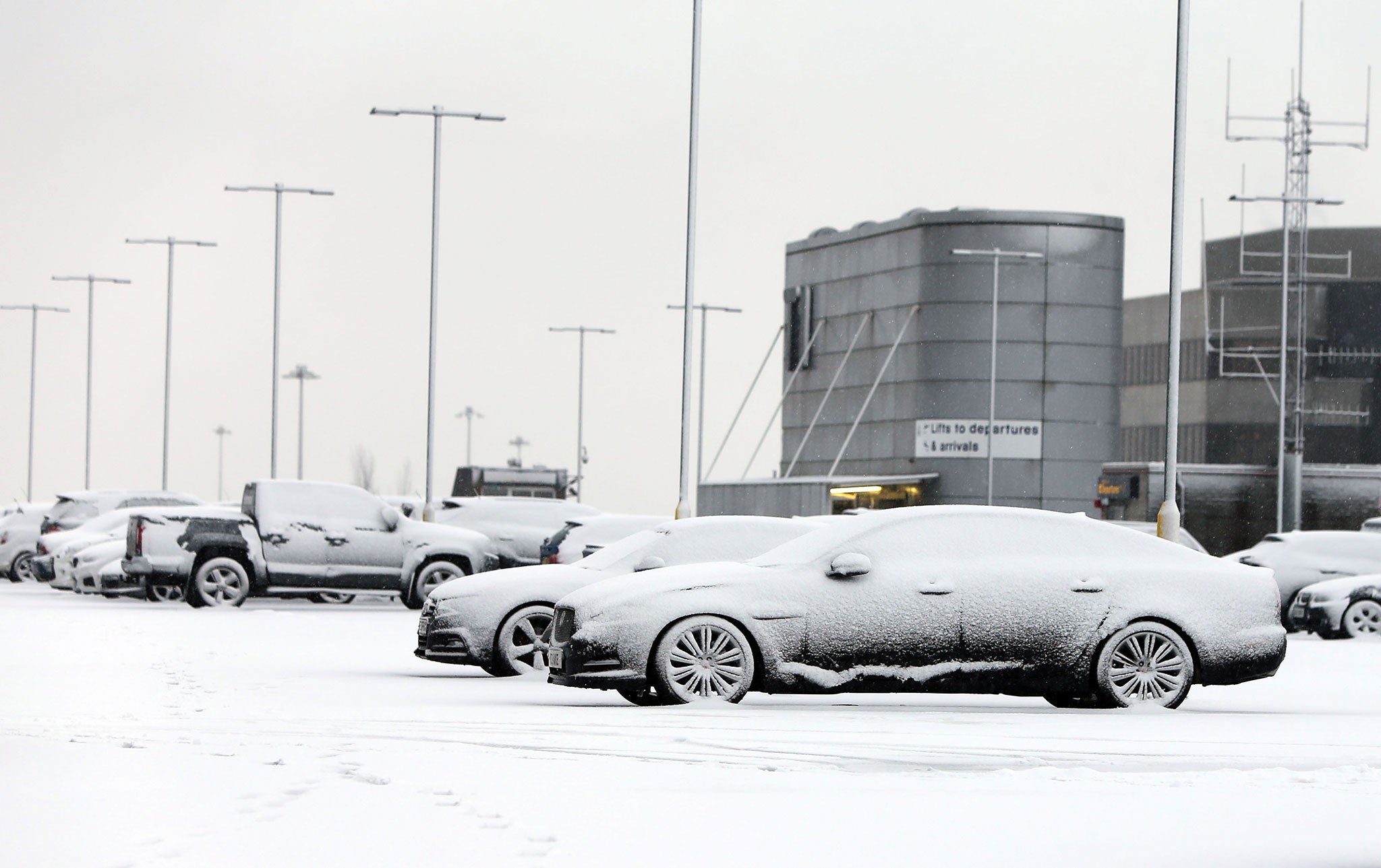 Cars covered in snow at the car park at Manchester Airport's Terminal 1