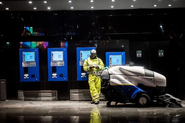 A street cleaners takes a quick break whilst working the night shift at Piccadilly Circus in London