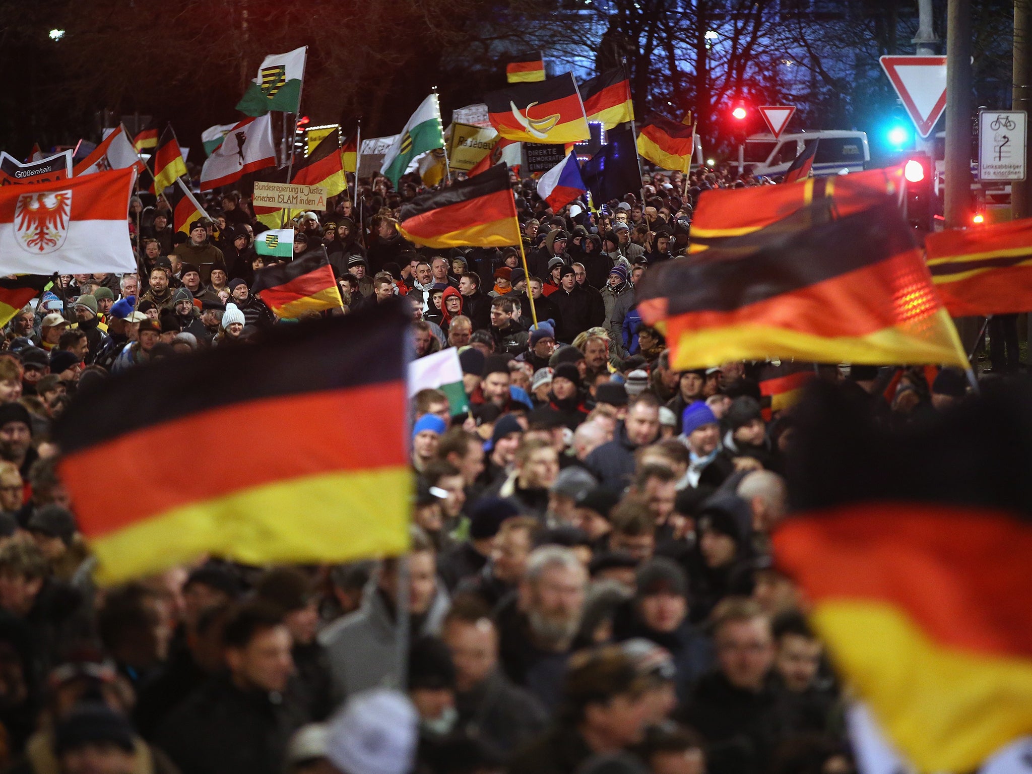 Supporters of the Pegida movement wave German and other flags