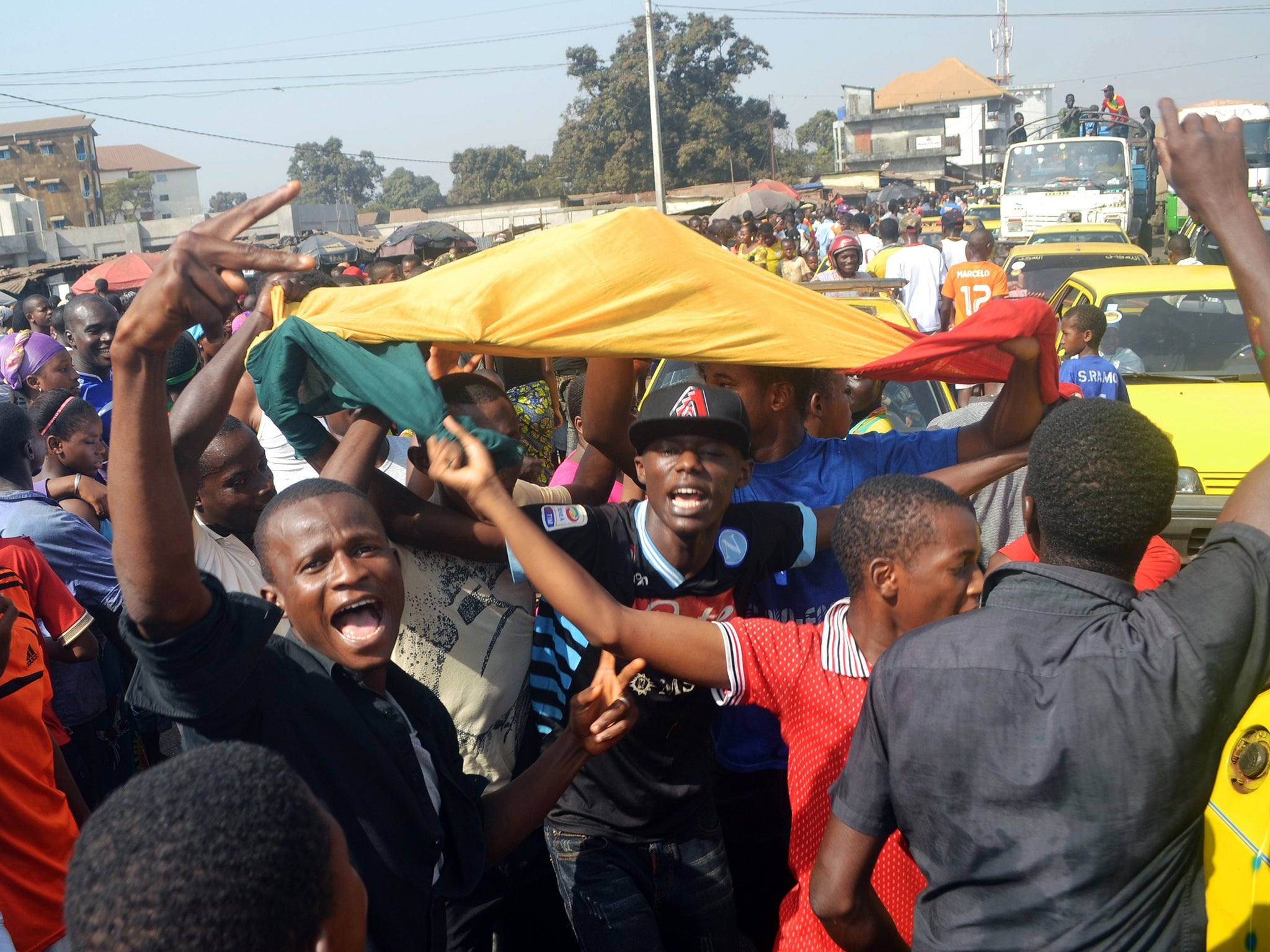 Guineans celebrate in the streets of Conakry after Guinea qualified for the Africa Cup of Nations quarter-finals