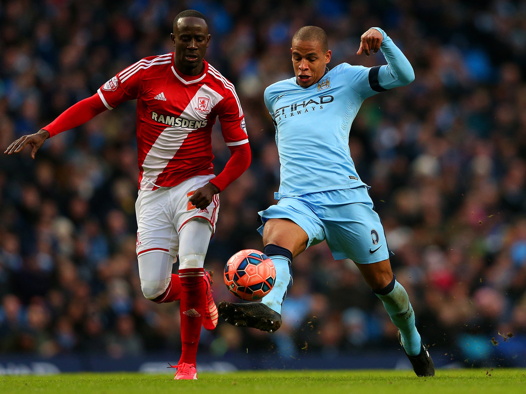 Albert Adomah of Middlesbrough chases Fernando of Manchester City as he underhits a backpass