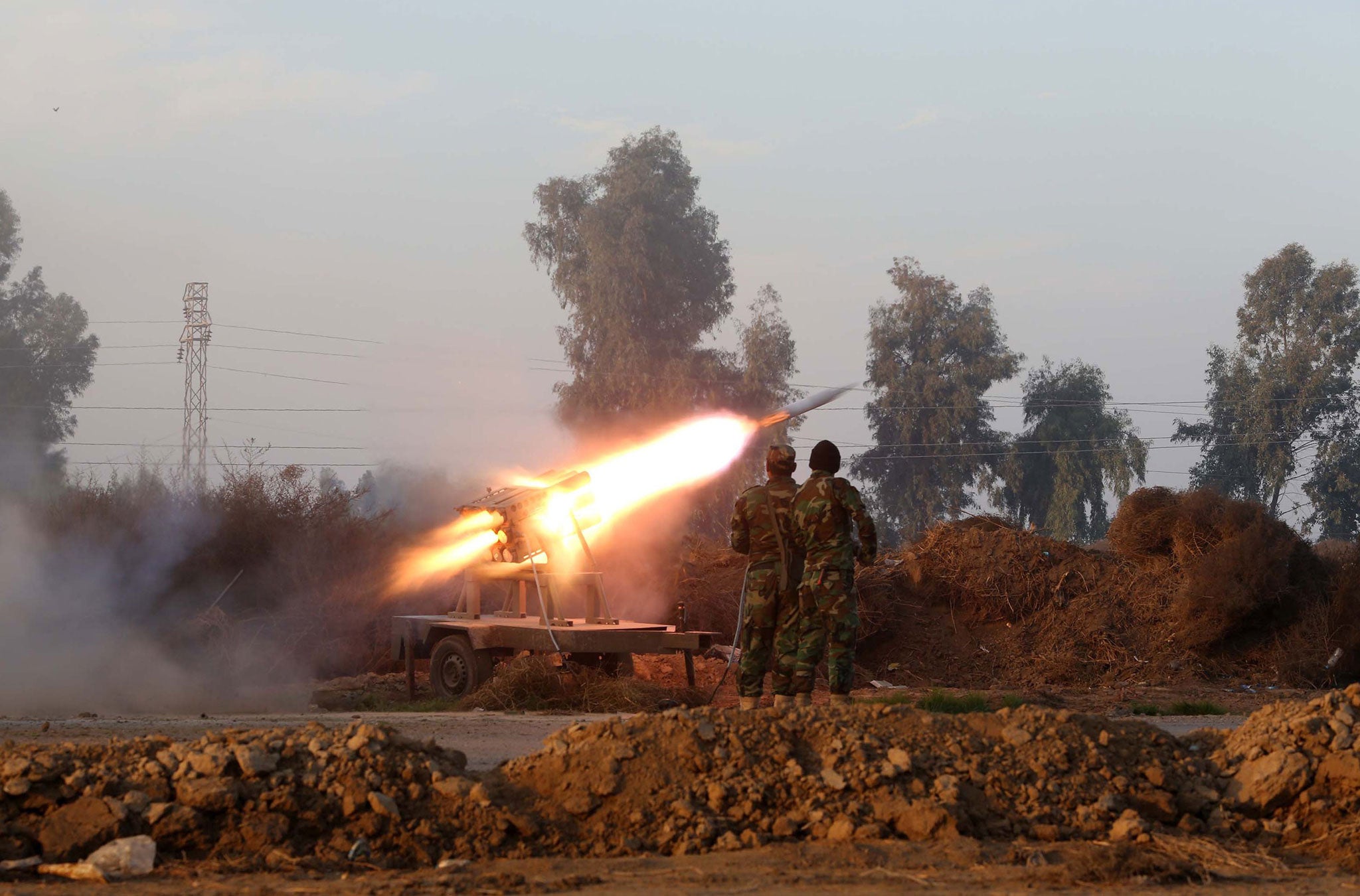 Iraqi soldiers launch a rocket during clashes with Islamic State fighters near Dujail in January (Getty)