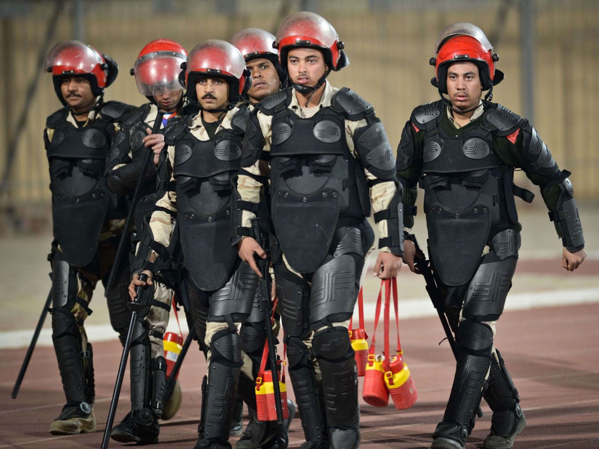 Egyptian policemen arrive at the stadium during before the Egyptian Premier League football match between Al-Ahly and Zamalek football clubs in Cairo on January 29, 2015.