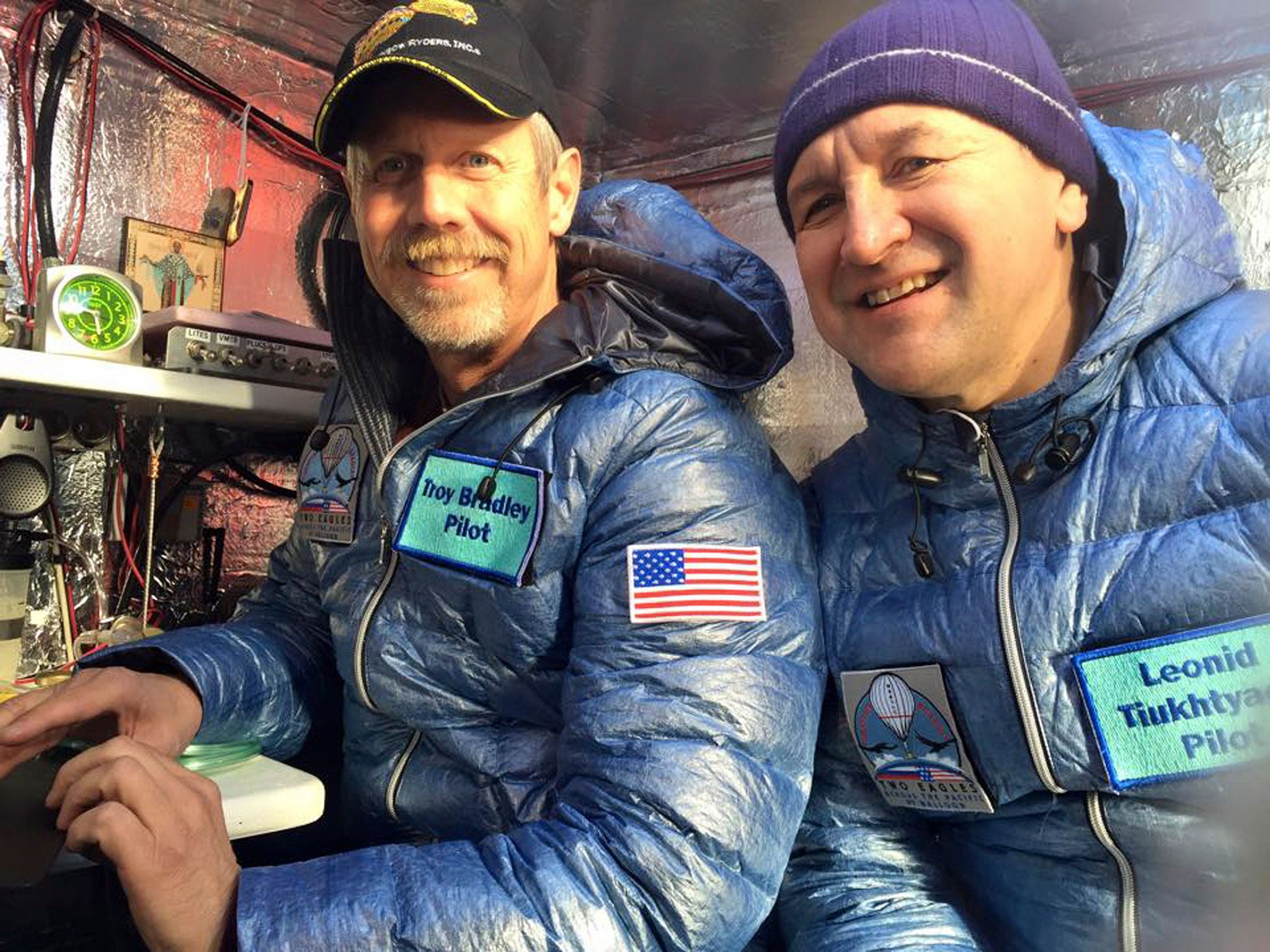 Pilots Troy Bradley (L) of the U.S. and Leonid Tiukhtayev of Russia sit in the capsule of the Two Eagles balloon before setting off on their attempt to cross the Pacific by balloon and set a new distance and duration record for gas balloon travel, in Saga