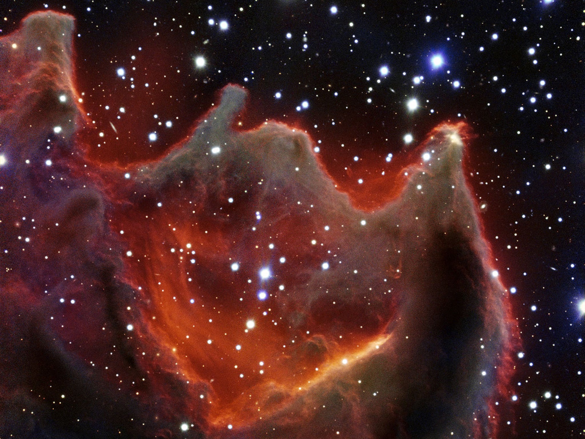 Like the gaping mouth of a gigantic celestial creature, the cometary globule CG4 glows menacingly in this new image from ESO’s Very Large Telescope. Although it appears to be big and bright in this picture, this is actually a faint nebula, which makes it