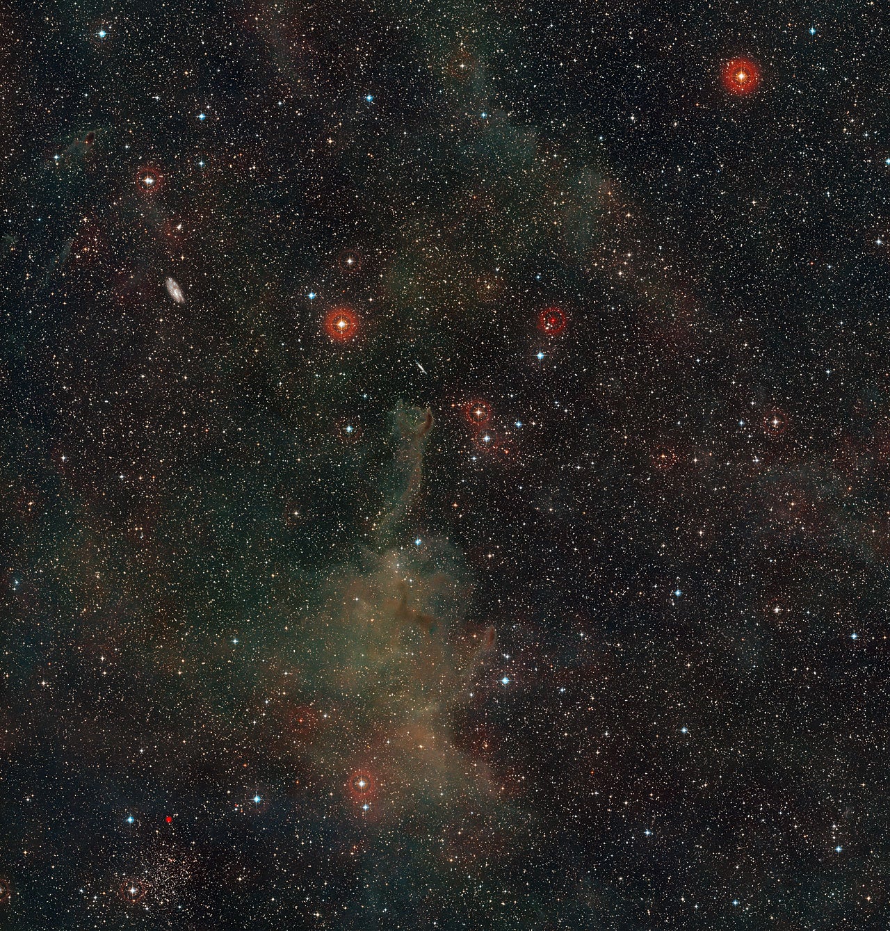 This wide-field image shows a rich region of the sky in the constellation of Puppis (The Poop). At the centre lies the strange cometary globule CG4. Other interesting objects are also seen, including several much more distant spiral galaxies