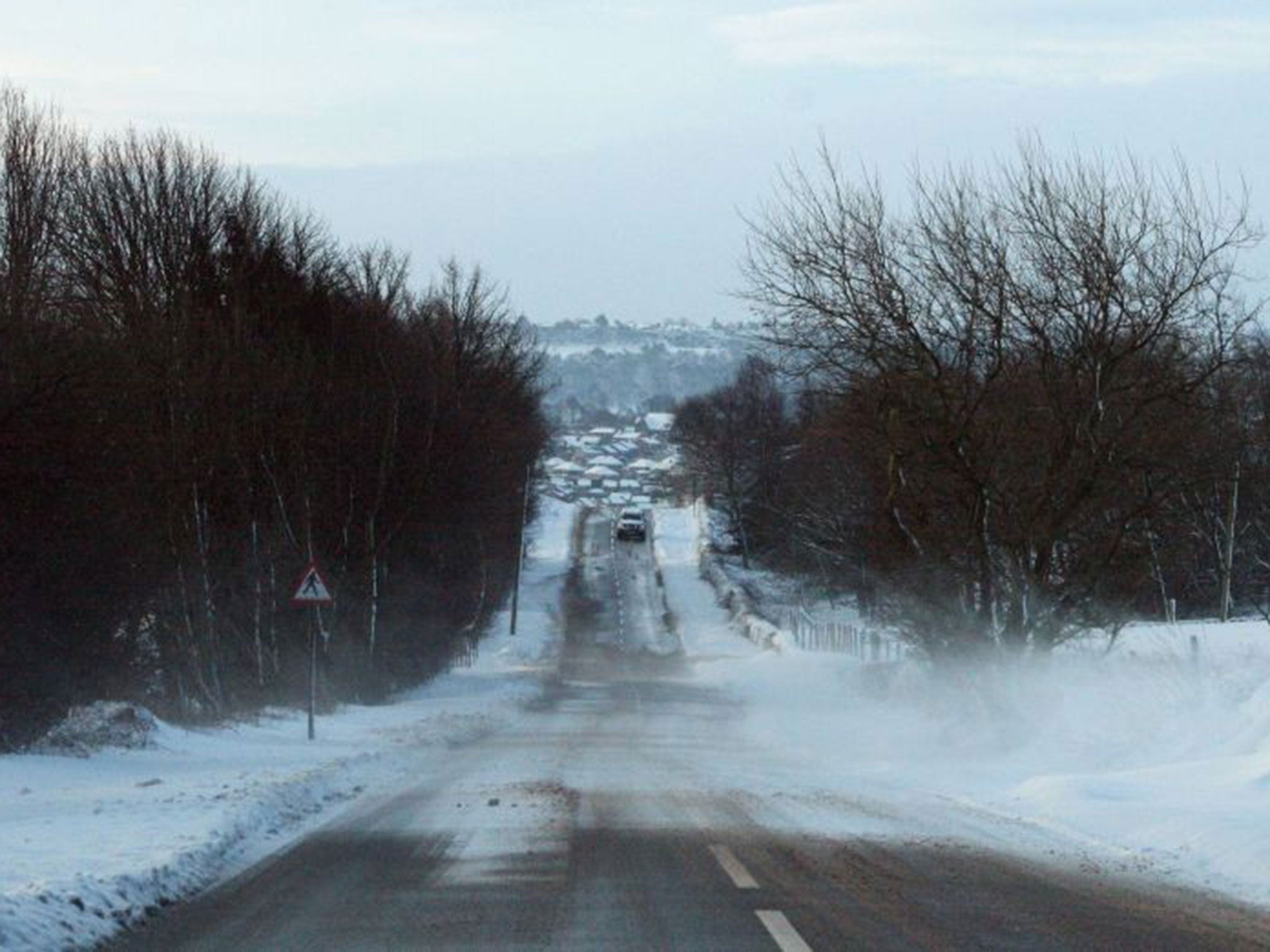 A car in the snow near Worrall, South Yorkshire, as Britons were warned to brace themselves for fresh disruption today