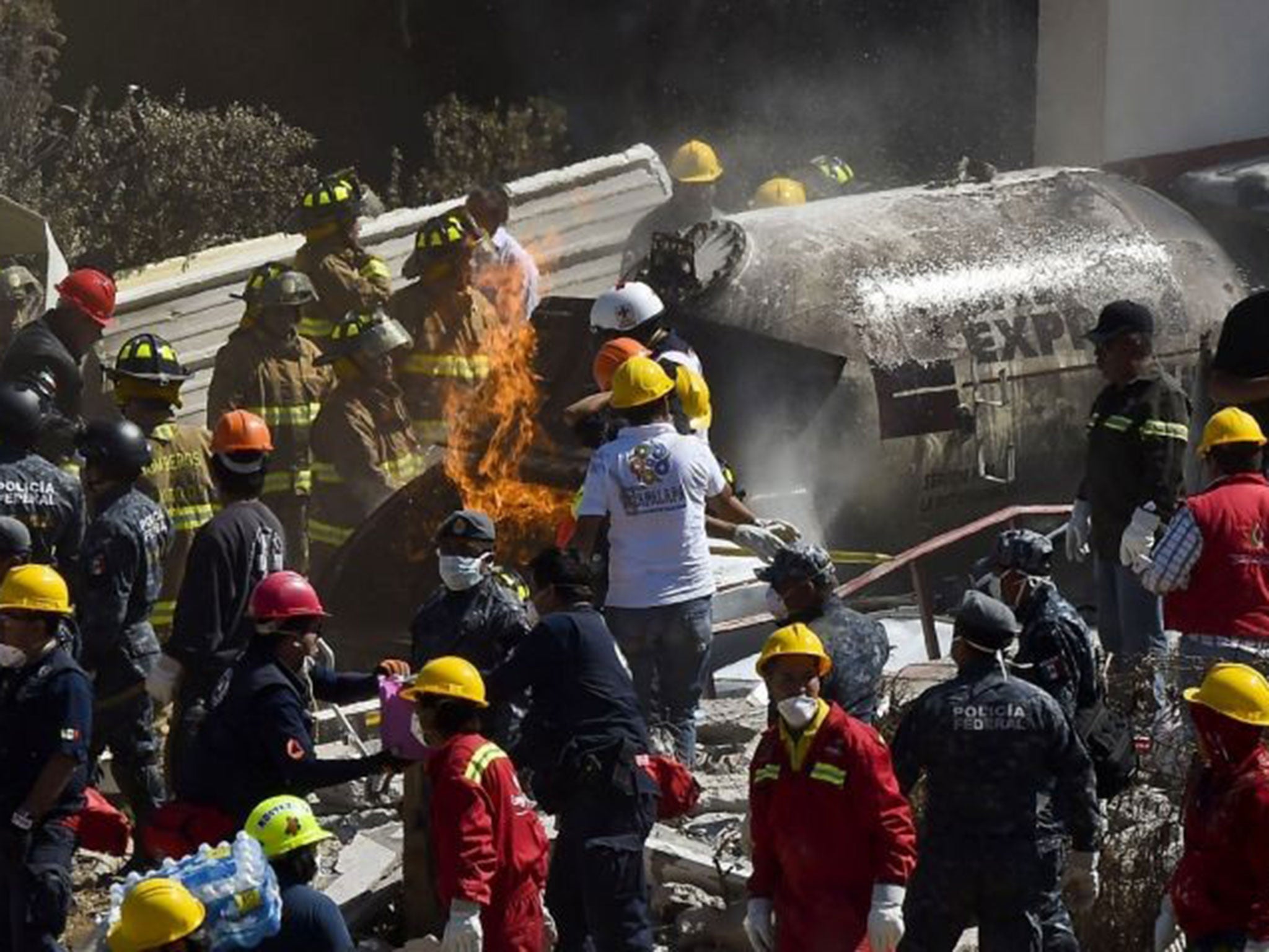 Rescuers work amid the wreckage caused by an explosion in a hospital in Cuajimalpa, Mexico City