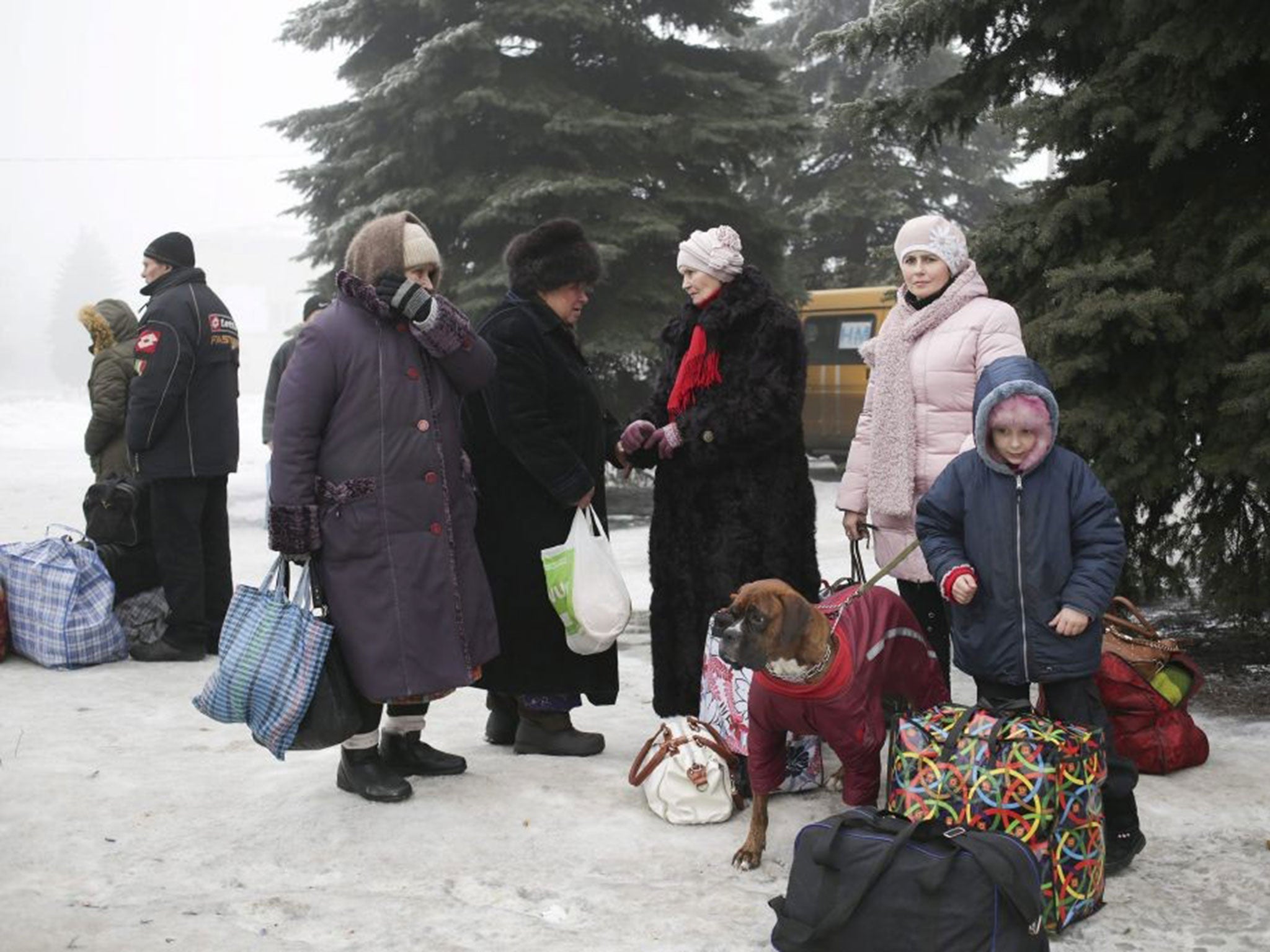 Families waiting for a bus to evacuate them from Debaltseve, Ukraine, on 30 January 2015.