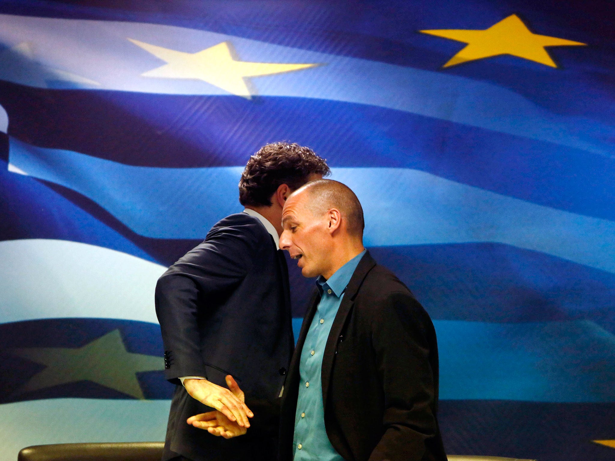 Jeroen Dijsselbloem, (L) head of the euro zone finance ministers' group, and Greek Finance Minister Yanis Varoufakis shake hands after their common press conference at the ministry in Athens. Greece's government will not cooperate with the EU and IMF miss