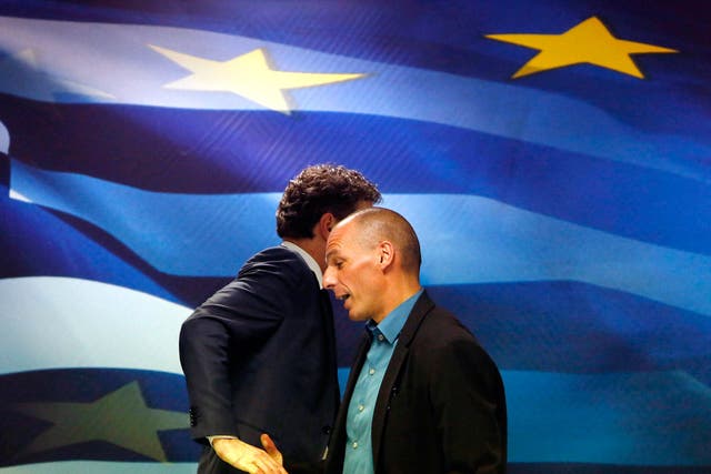 Jeroen Dijsselbloem, (L) head of the euro zone finance ministers' group, and Greek Finance Minister Yanis Varoufakis shake hands after their common press conference at the ministry in Athens. Greece's government will not cooperate with the EU and IMF miss