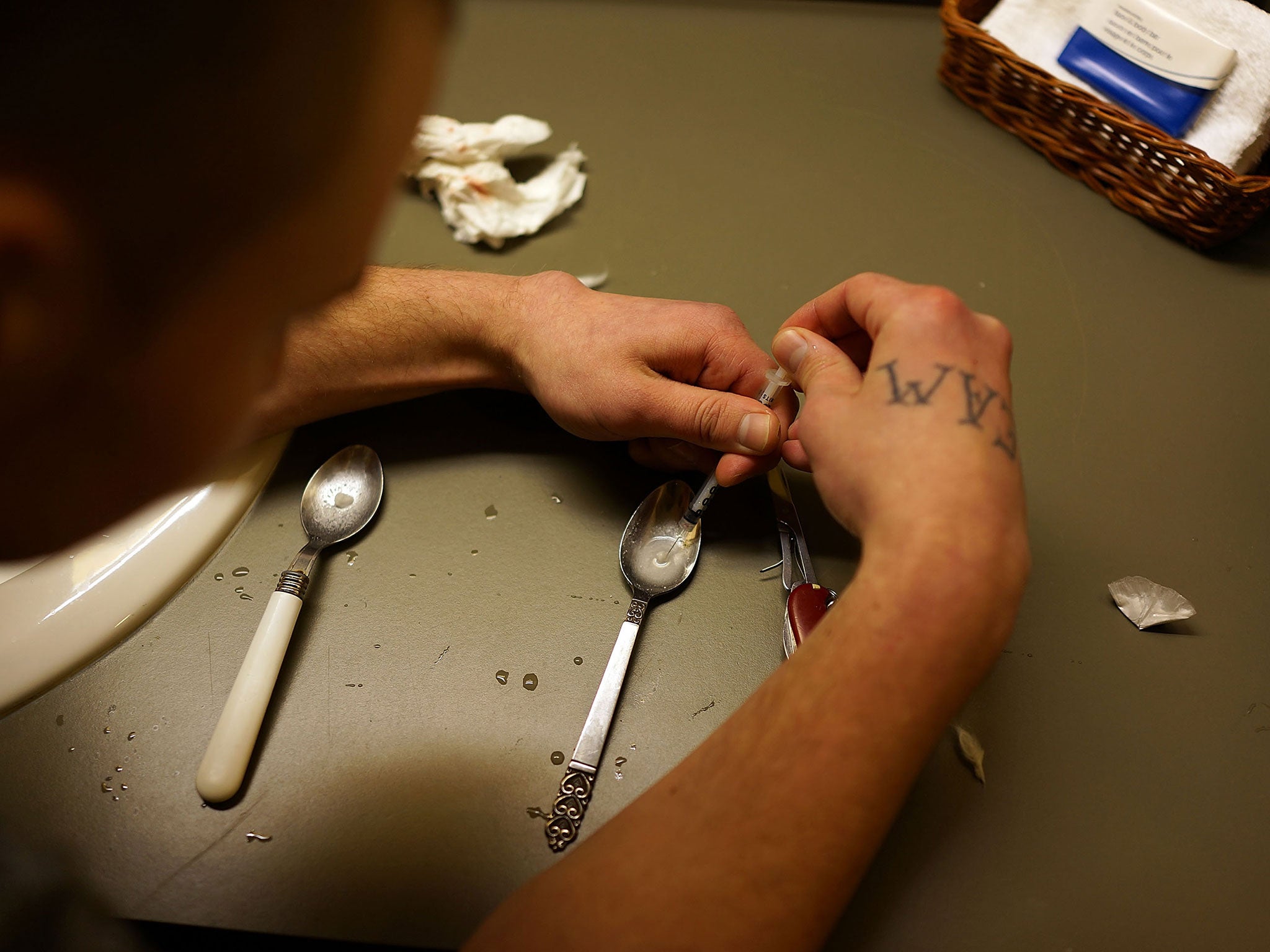 A user prepares to inject heroin