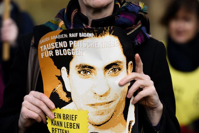 A woman protests the imprisonment and flogging of Raif Badawi