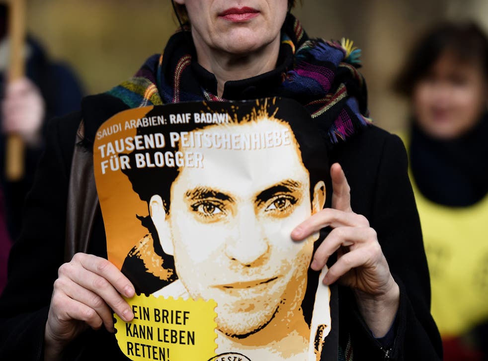 A woman protests the imprisonment and flogging of Raif Badawi