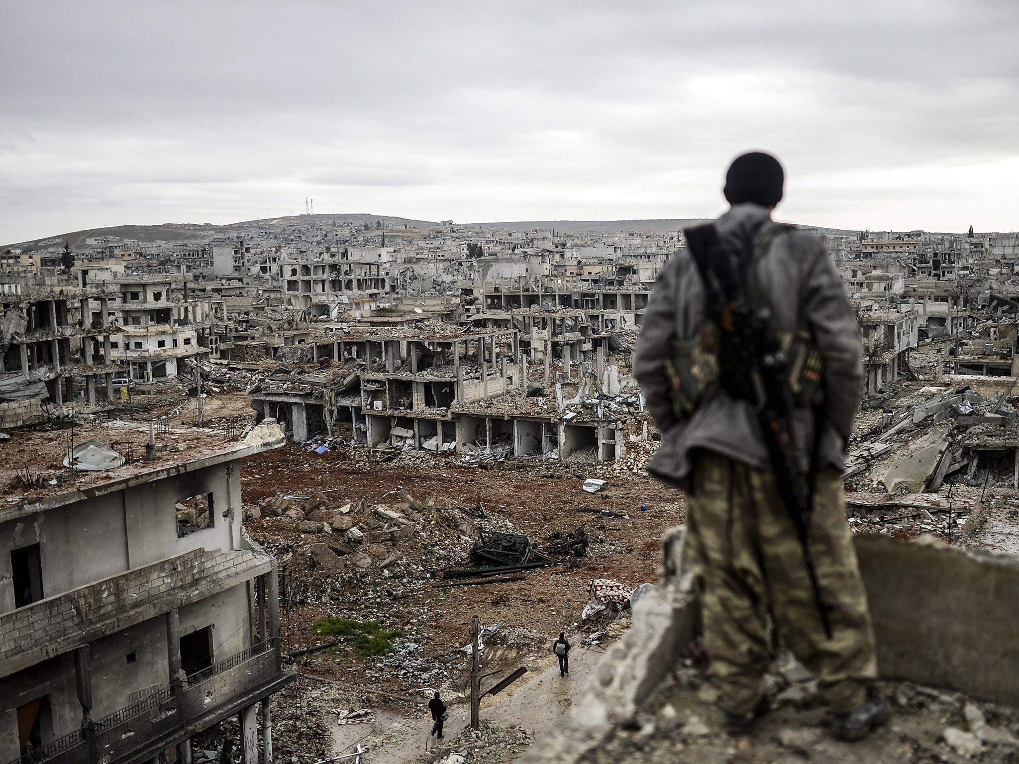 A Kurdish marksman surveys the Syrian city of Halimce yesterday, recaptured from Isis last week