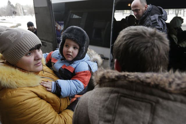 Civilians in Debaltseve board an evacuation bus on Saturday (AP)