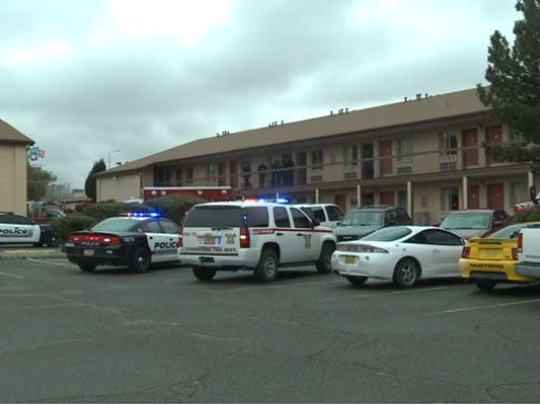 Police vehicles outside the motel in Albuquerque, New Mexico where a boy shot his parents