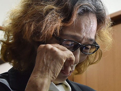 Junko Ishido, mother of the executed hostage, cries after the release of the Isis video