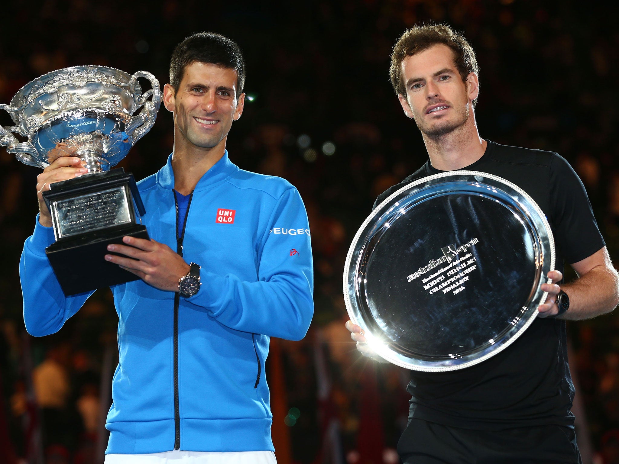 Djokovic holds his trophy next to runner-up Murray