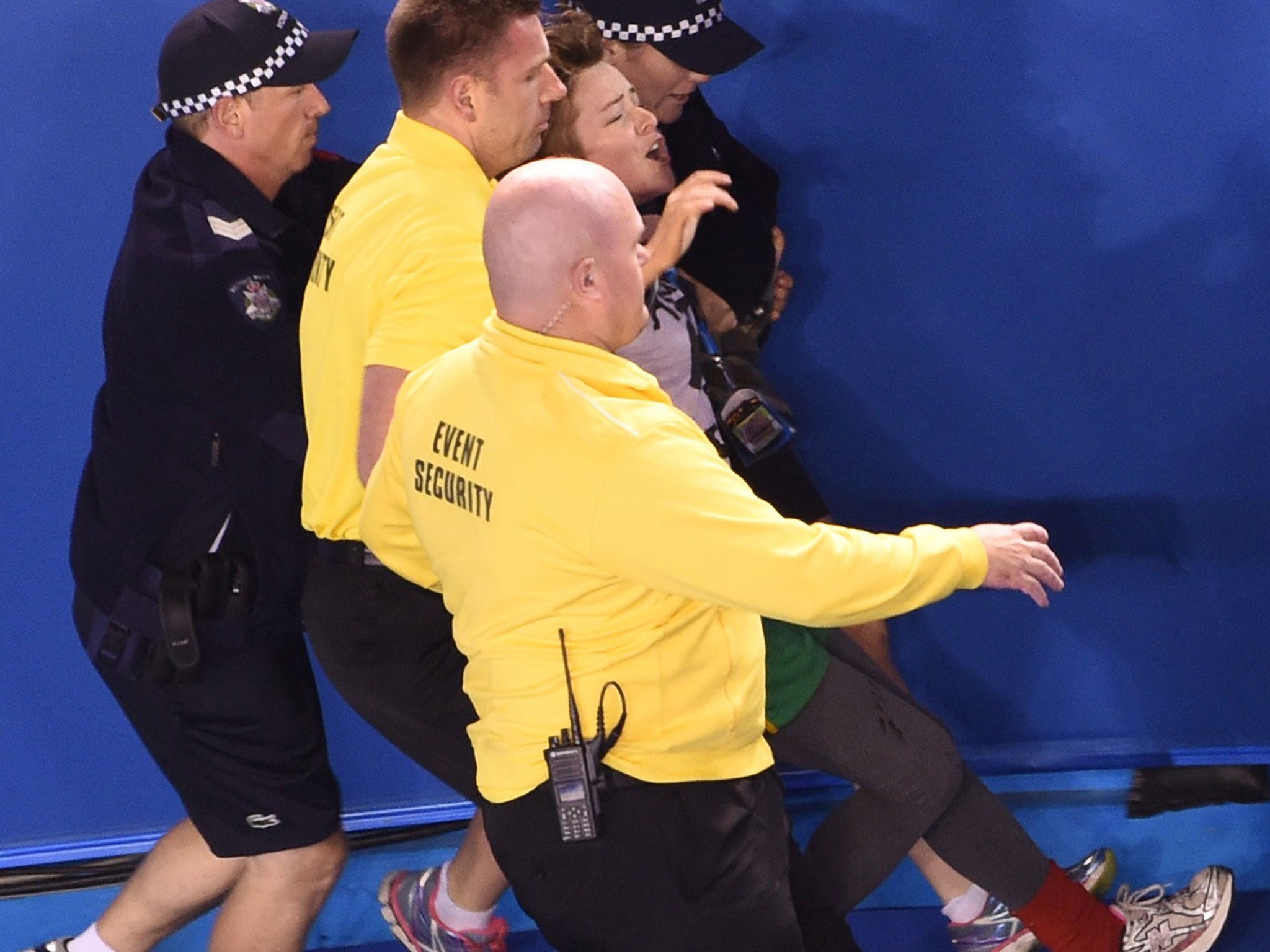 Security staff escort a protester out of the Rod Laver Arena