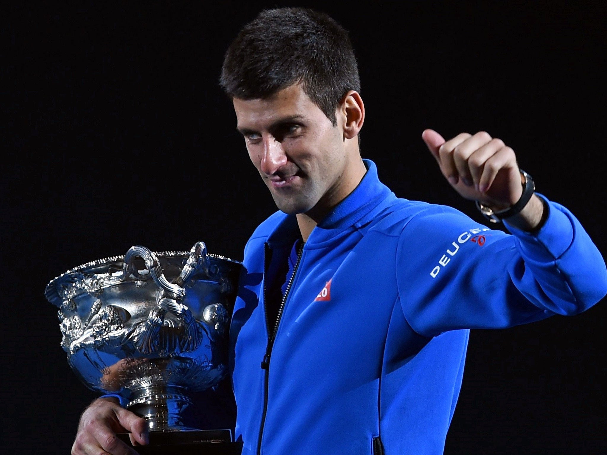 Novak Djokovic lifts his Australian Open trophy