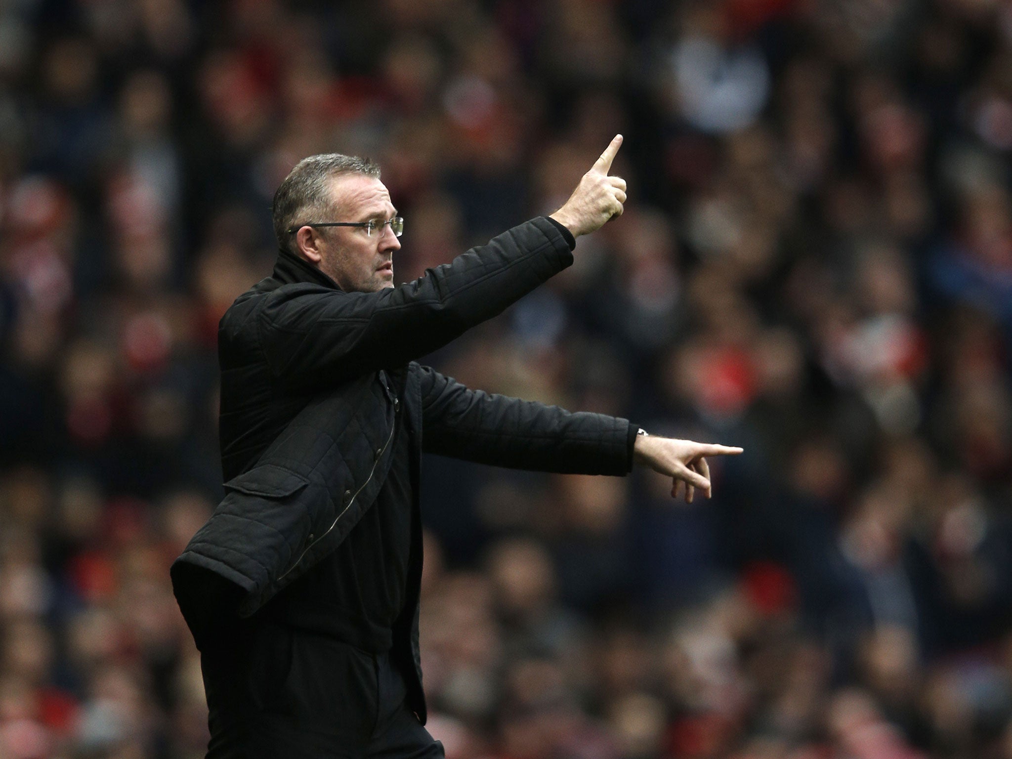 Paul Lambert makes a gesture on the touchline at the Emirates