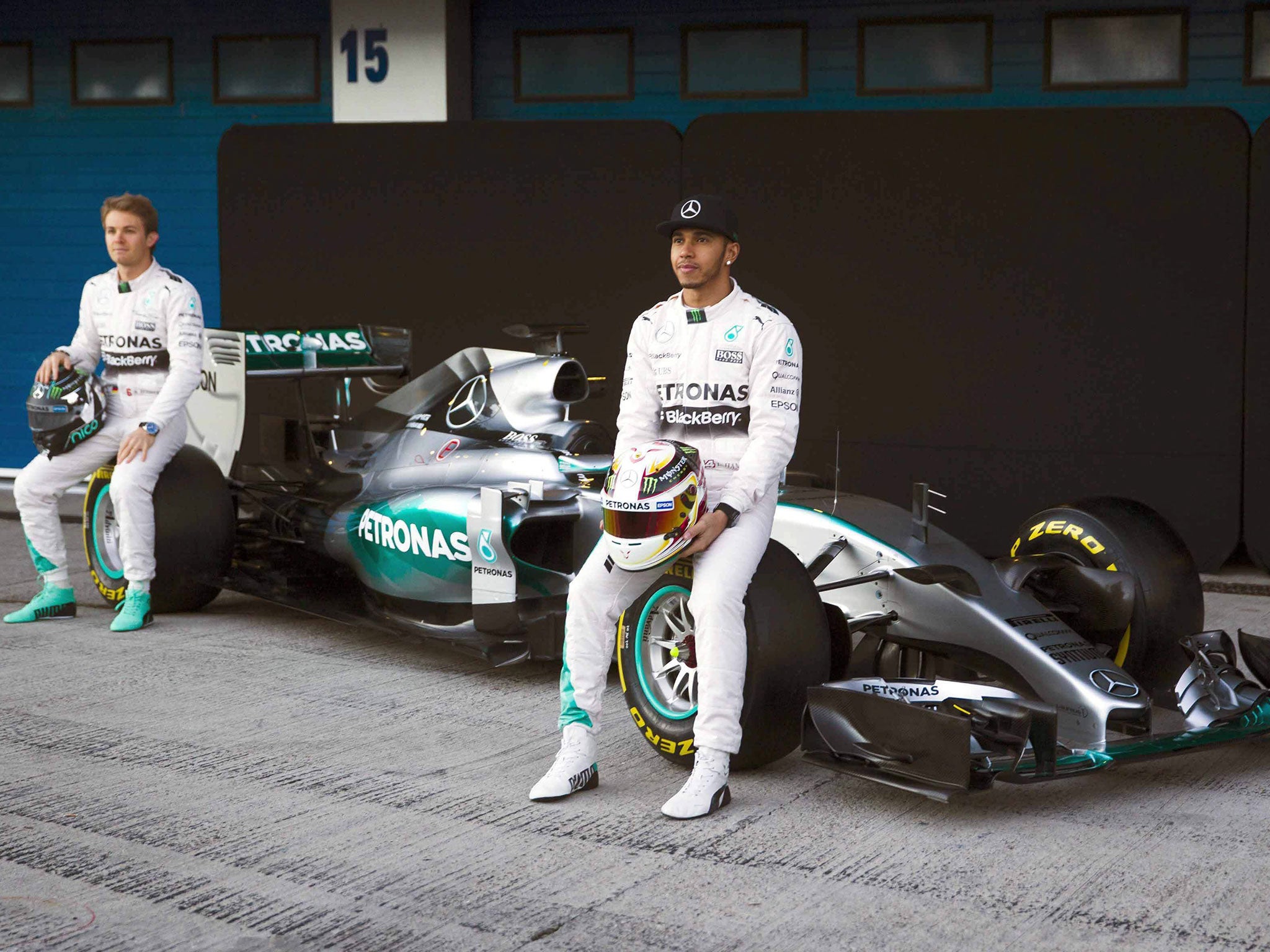 Lewis Hamilton, right, and Nico Rosberg pose with the new Mercedes W06 car in Spain