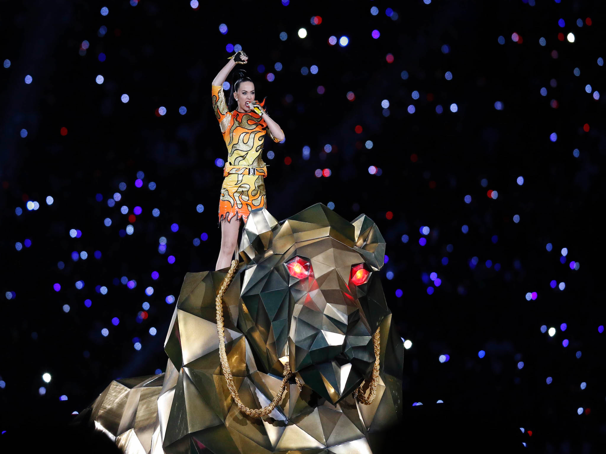 Katy Perry appeared on the back of a metallic lion (or tiger)