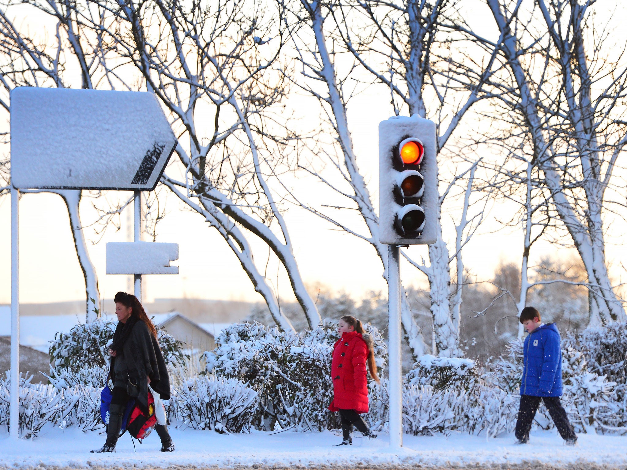 People walking in the heavy snow in Glasgow