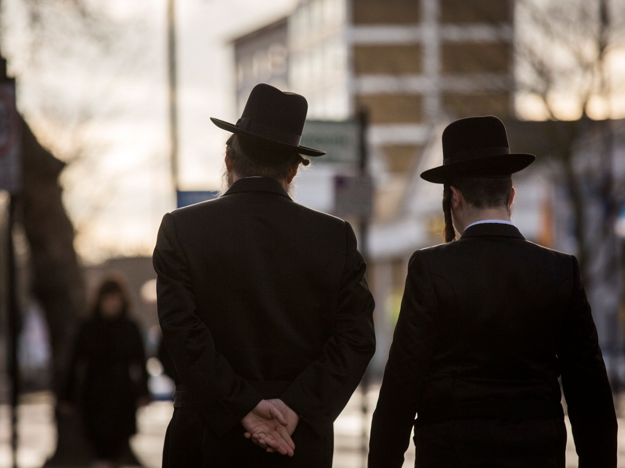 Jewish men walk along the street in Stamford Hill, where far-right nationalists are planning a protest