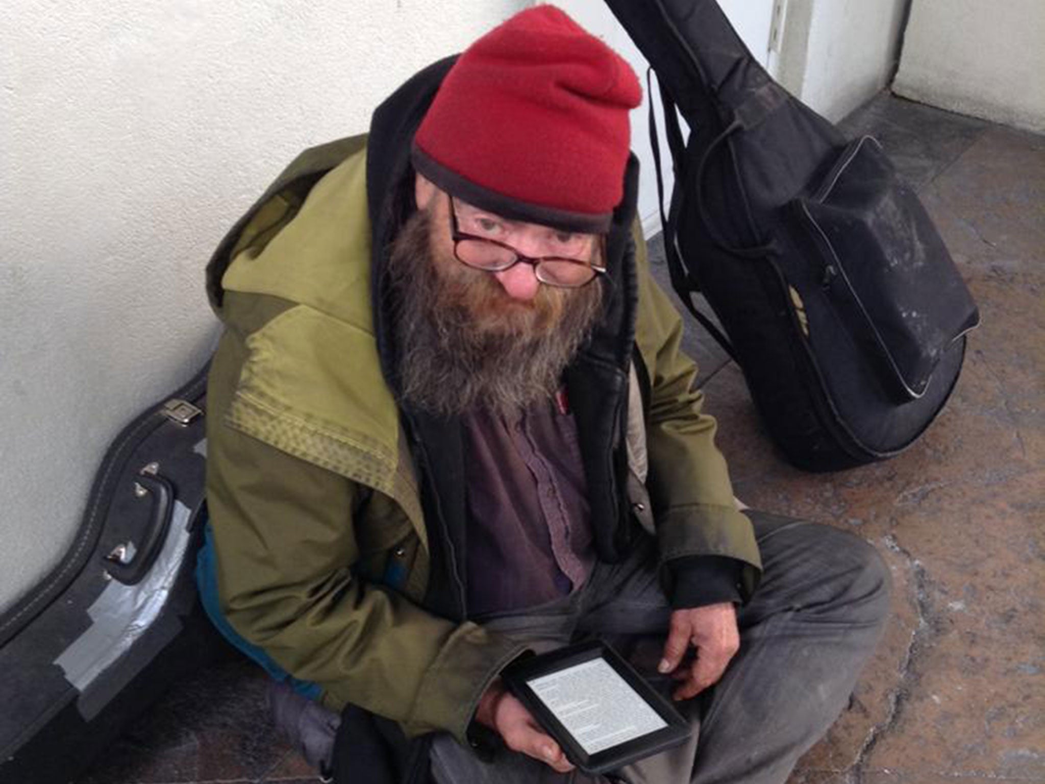 A homeless man named Paul holds the Kindle a stranger gave him
