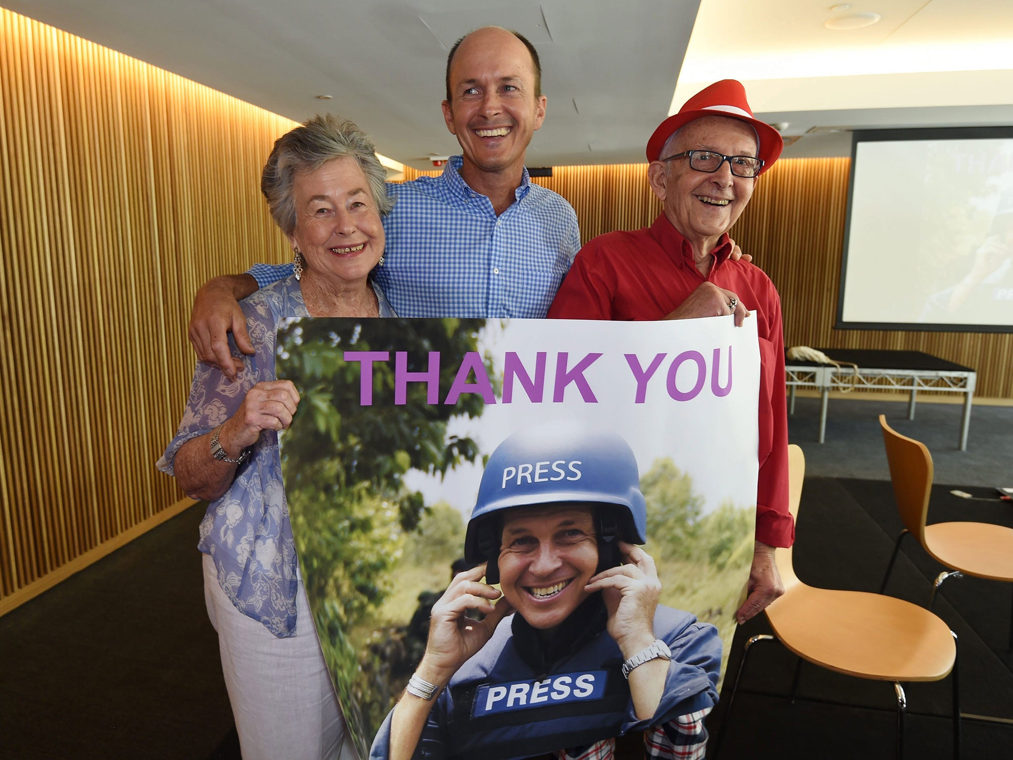 The family of Australian journalist Peter Greste (L-R) mother Lois, brother Andrew and father Juris, pose in celebration with a picture of Peter Greste during a press conference in Brisbane, Australia, 02 February 2015.