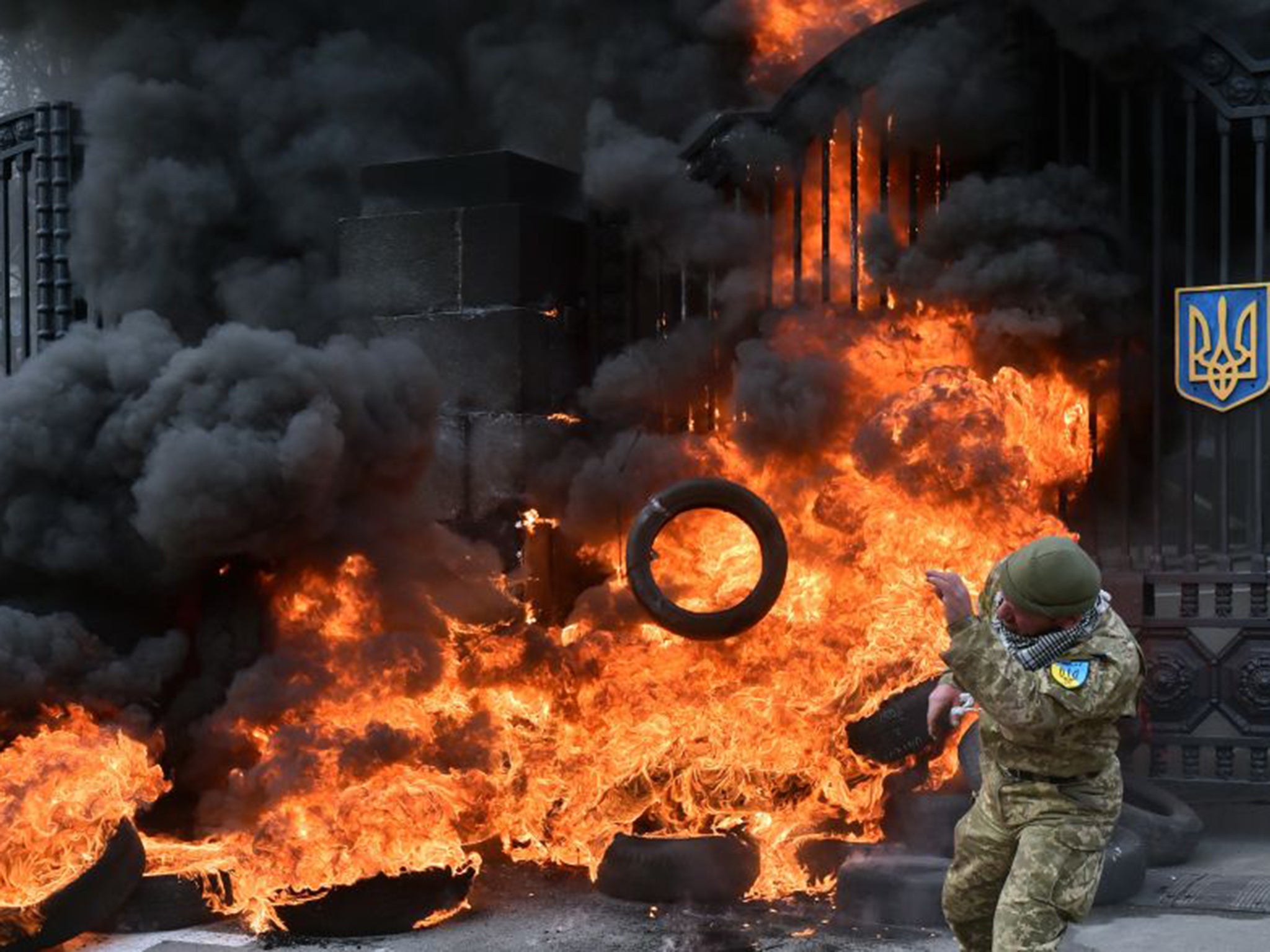 Fighters from the Aydar Ukrainian volunteer battalion burn tyres at the entrance to the Ukrainian Defence Ministry during demonstrations against their possible disbandment in Kiev on Monday (AFP/Getty)