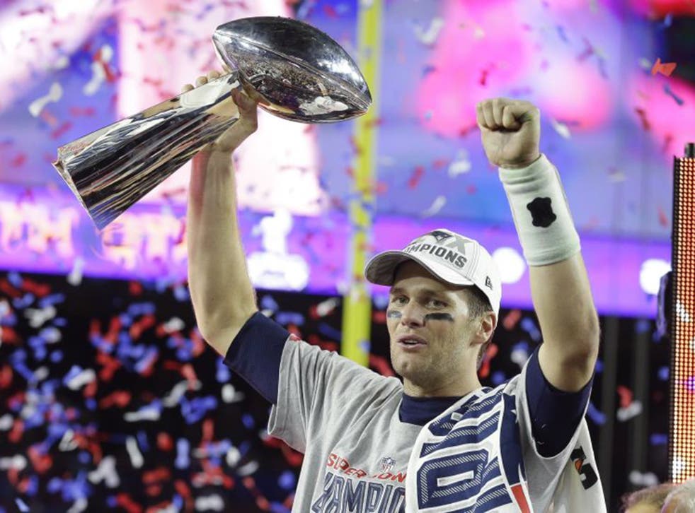 Patriots quarterback Tom Brady celebrates with the Vince Lombardi Trophy on Sunday night (AP)