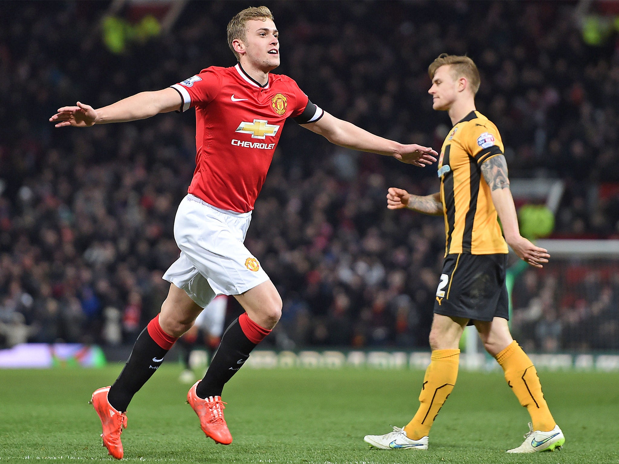 James Wilson celebrates after scoring Manchester United's third goal