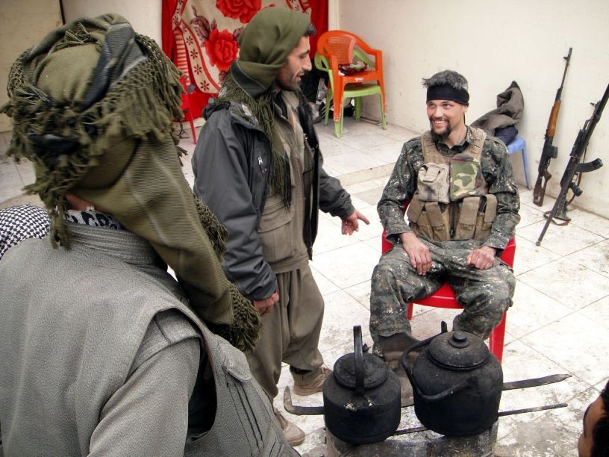 Former US soldier Jordan Matson, right, with Kurdish fighters surrounded by machine guns