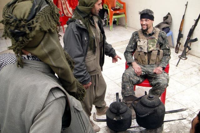 Former US soldier Jordan Matson, right, with Kurdish fighters surrounded by machine guns