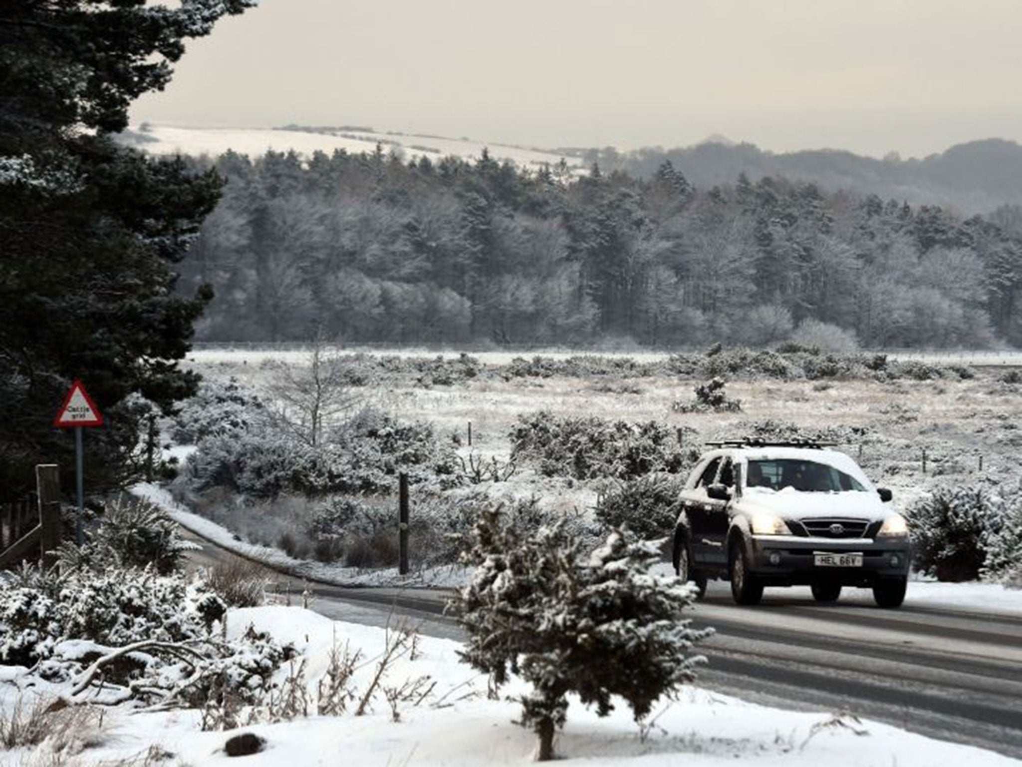 A car makes it's way through the snow on the Yorkshire Moors,