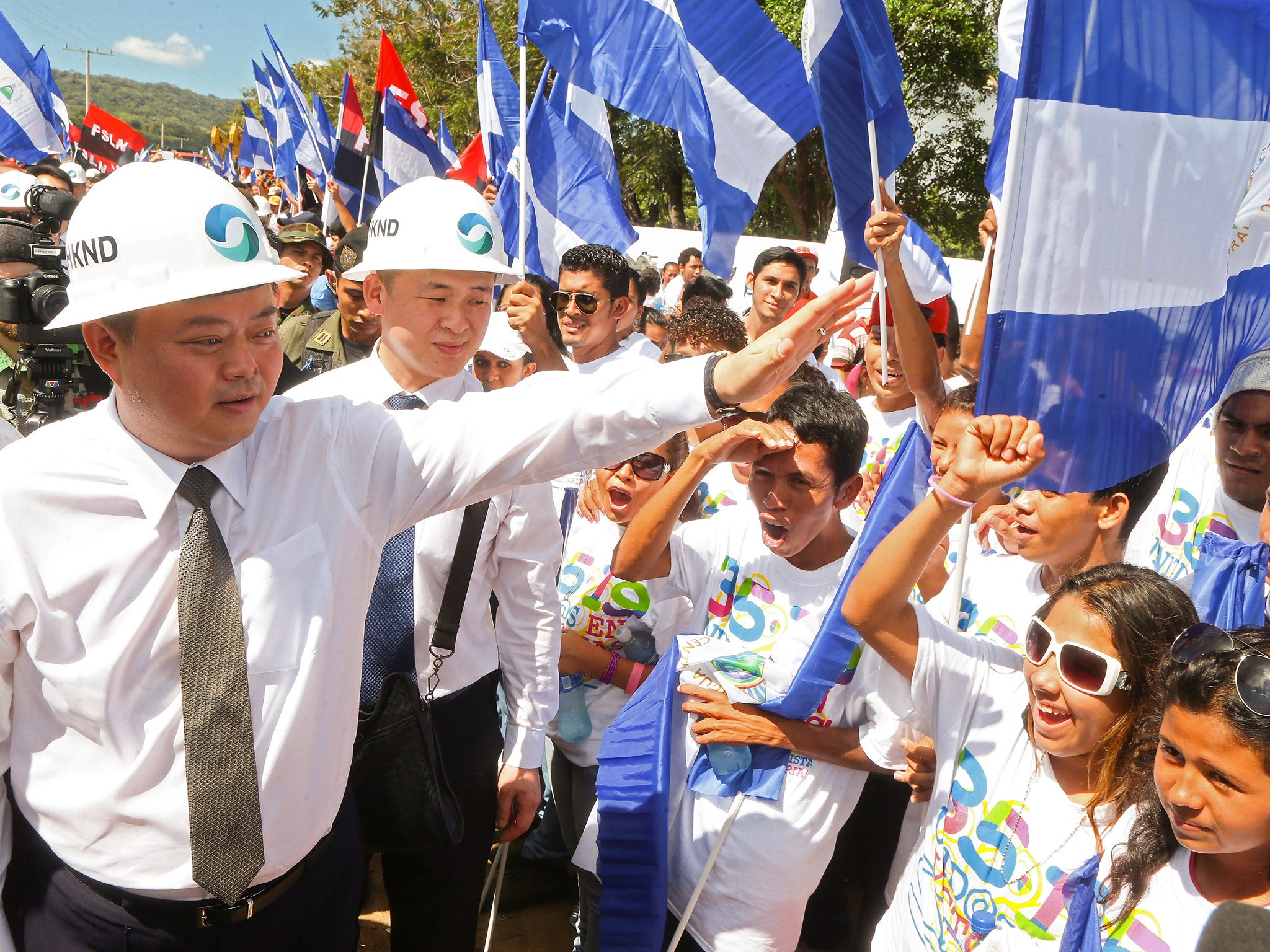 Chinese businessman Wang Jing (left) greets members of the Sandinista National Liberation Front during the inauguration of the works of an inter-oceanic canal in Tola, some 3 km from Rivas, Nicaragua, in December 2014