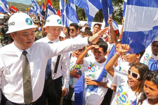 Chinese businessman Wang Jing (left) greets members of the Sandinista National Liberation Front during the inauguration of the works of an inter-oceanic canal in Tola, some 3 km from Rivas, Nicaragua, in December 2014