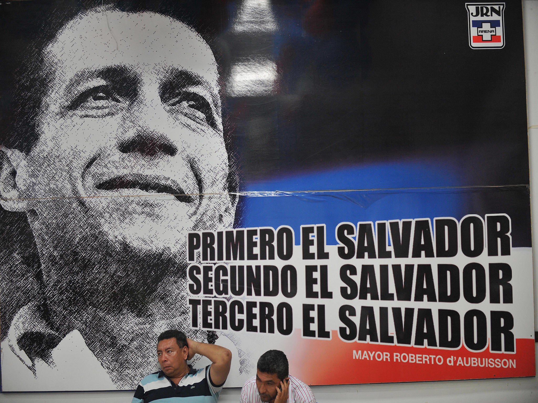 Supporters of El Salvador's National Republican Alliance and a banner showing its founder Roberto D'aubuisson