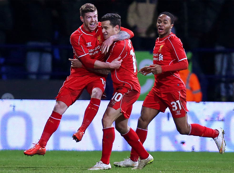 Philippe Coutinho, centre, enjoys his late winner with Alberto Moreno (left) and Raheem Sterling