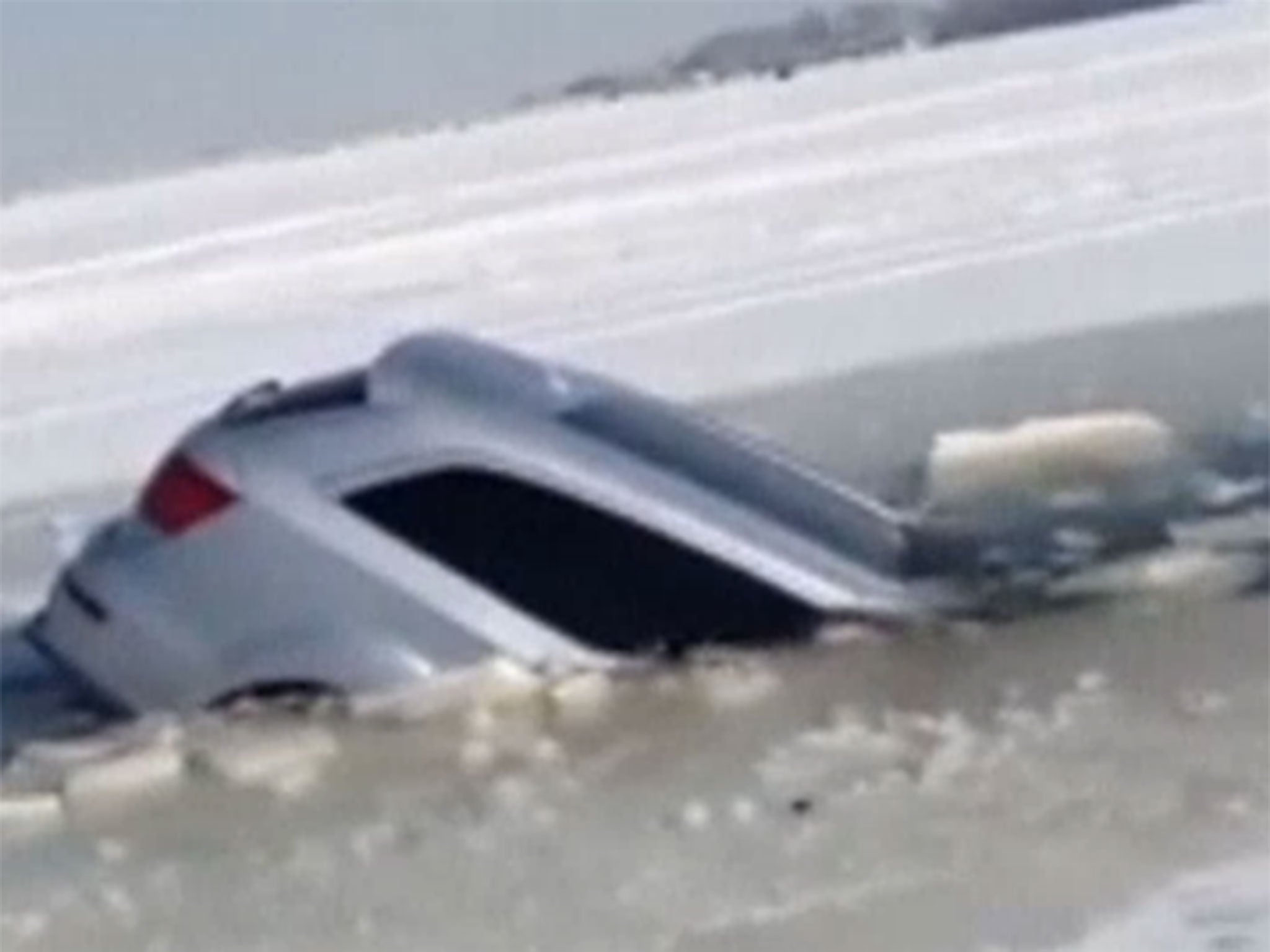 Car in China plunges into frozen reservoir