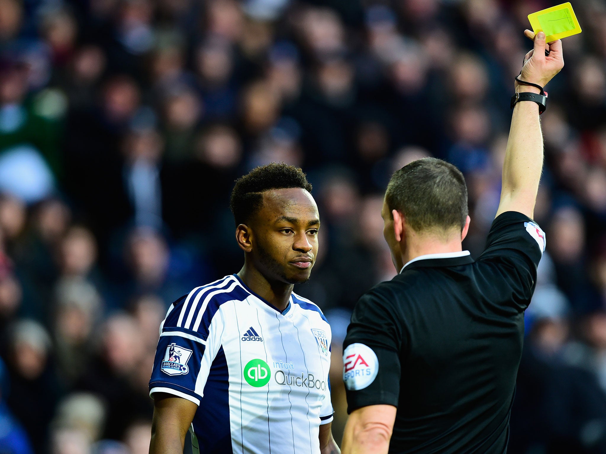Saido Berahino is booked during the defeat to Spurs